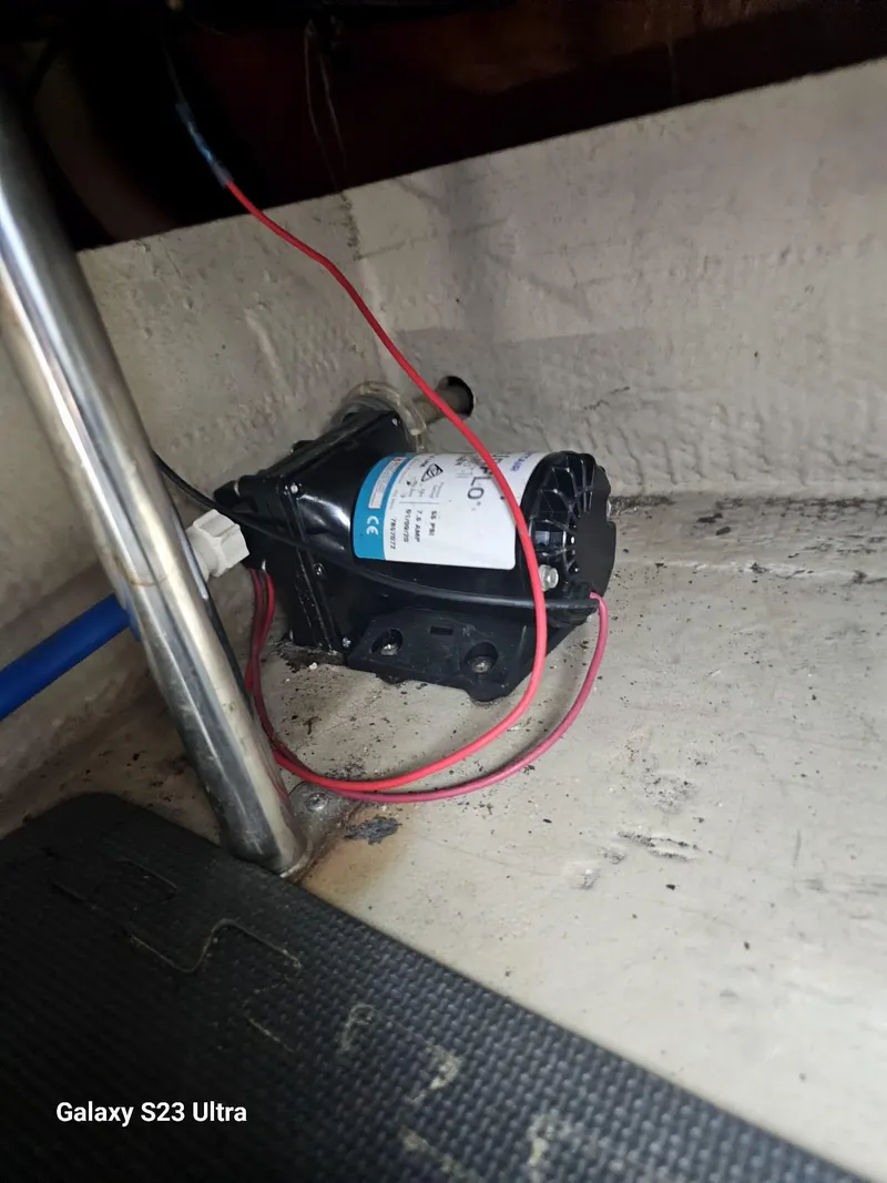 Slide: The Image of Boat interior showing a pump with red wiring, Regal 2800 LSR, 2000 model. - 17