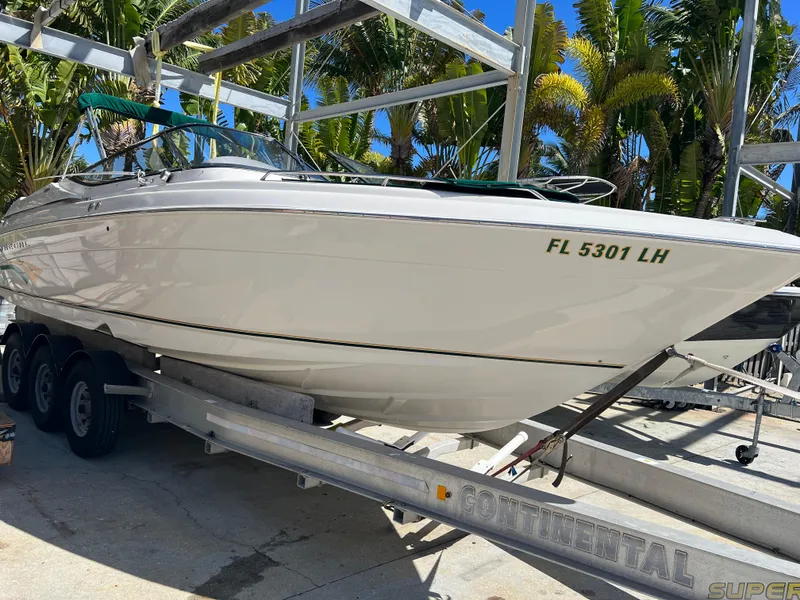 Slide: The Image of 2000 Regal 2800 LSR boat on trailer, surrounded by palm trees. - 3
