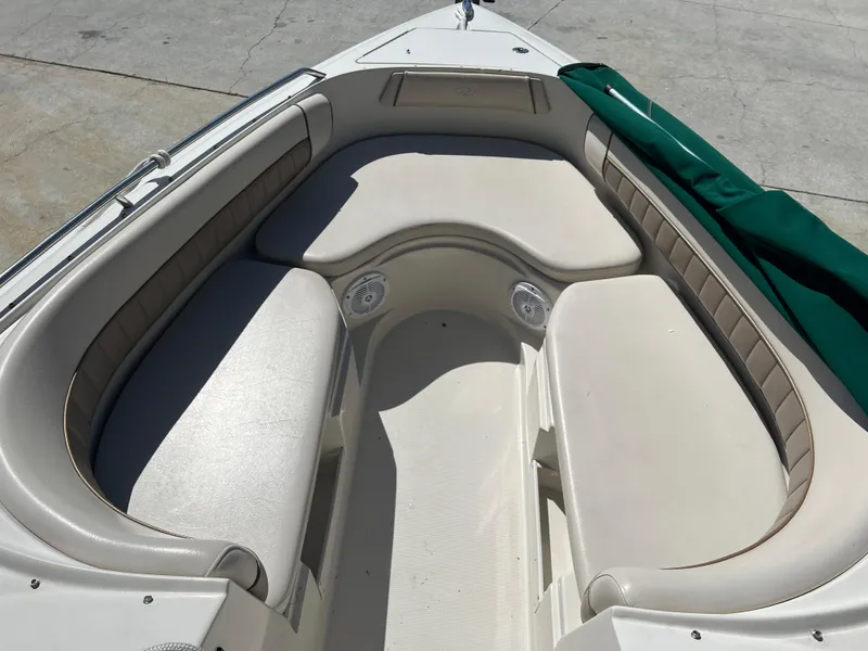 Slide: The Image of 2000 Regal 2800 LSR boat interior with beige seating and green cover. - 4