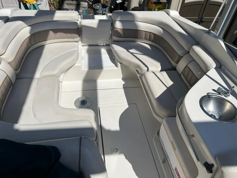Slide: The Image of 2000 Regal 2800 LSR boat interior with spacious seating and built-in sink. - 7