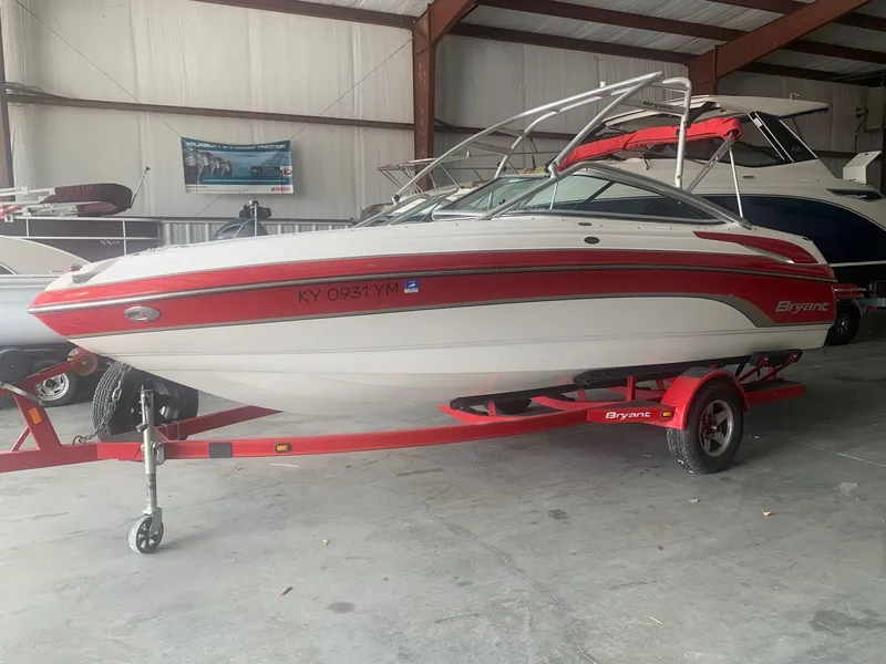 Slide: The Image of 2006 Bryant 206 BR boat with red and white design on trailer in storage facility. - 0