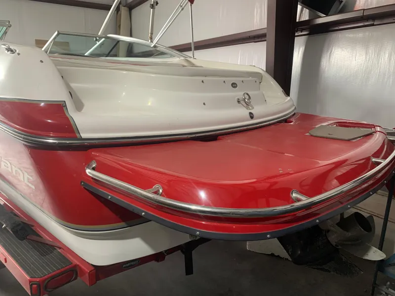 Slide: The Image of 2006 Bryant 206 BR boat with red and white exterior in a storage facility. - 10