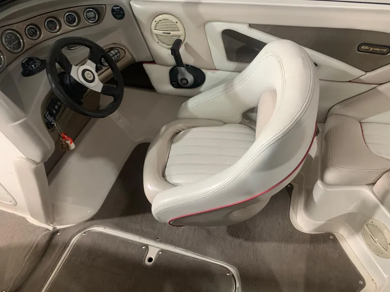 Slide: The Image of Interior of a 2006 Bryant 206 BR boat with steering wheel and seating. - 11