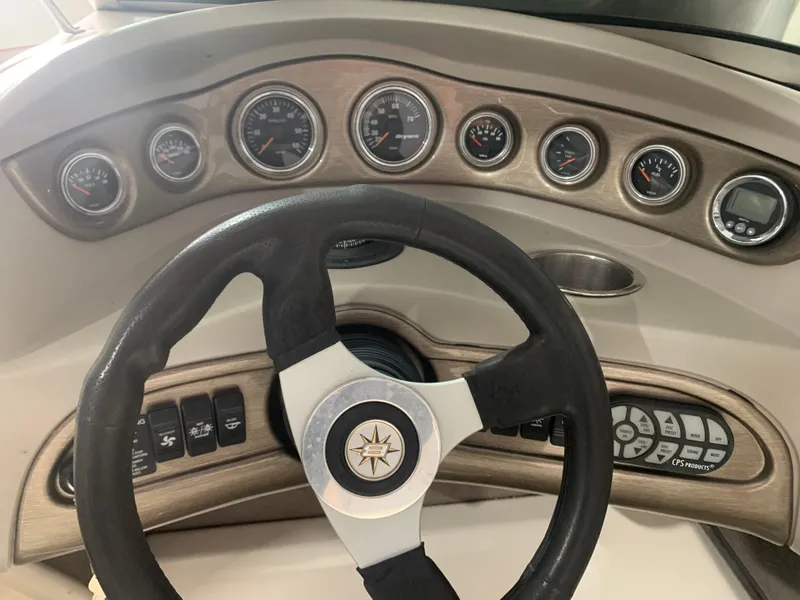 Slide: The Image of Dashboard of a 2006 Bryant 206 BR boat with steering wheel and gauges. - 12