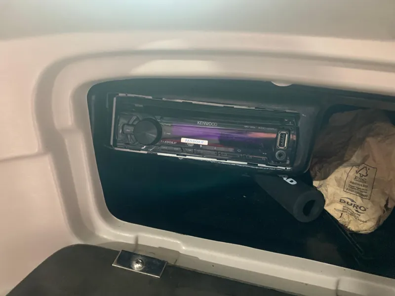 Slide: The Image of Kenwood stereo installed in a 2006 Bryant 206 BR boat dashboard compartment. - 13