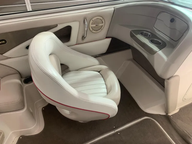 Slide: The Image of 2006 Bryant 206 BR boat interior with white seating and cup holders. - 14
