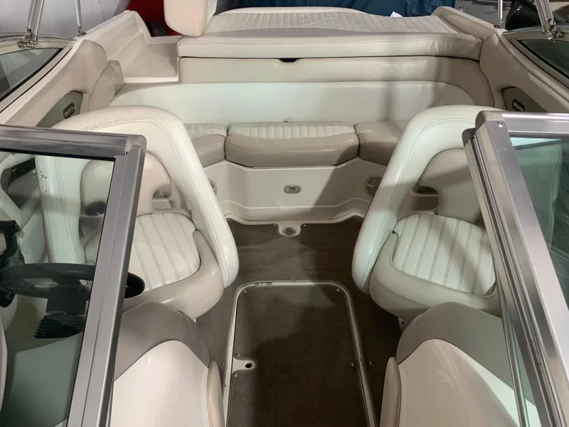 Slide: The Image of Interior of a 2006 Bryant 206 BR boat with white seating and carpeted floor. - 17