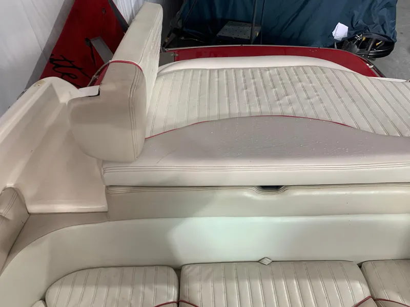 Slide: The Image of 2006 Bryant 206 BR boat interior with white cushioned seating and red accents. - 18