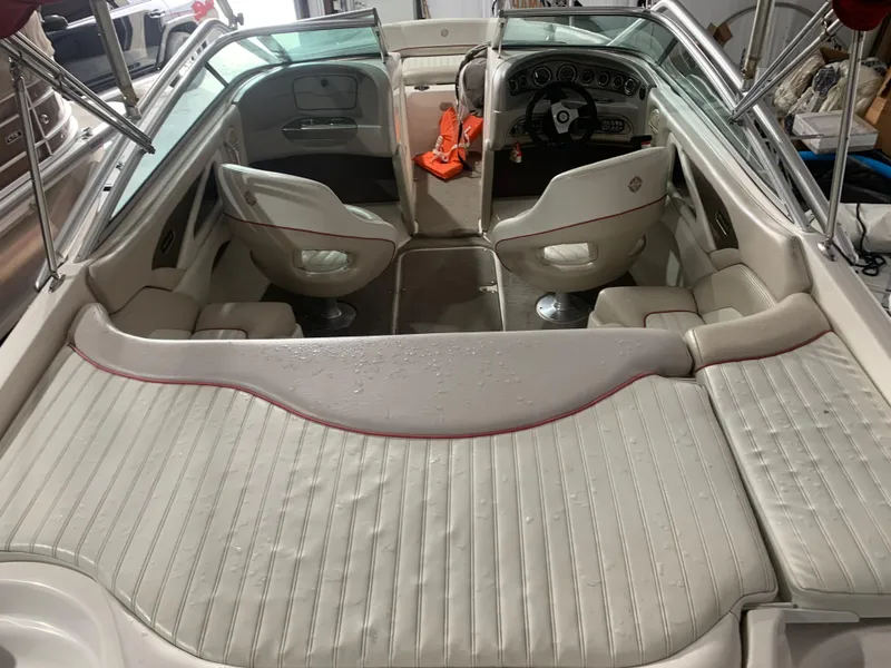 Slide: The Image of Interior of a 2006 Bryant 206 BR boat with white seating and dashboard. - 19