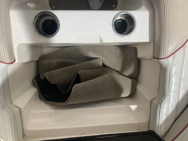 Slide: The Image of Rear seating area of a 2006 Bryant 206 BR boat with folded carpet. - 22