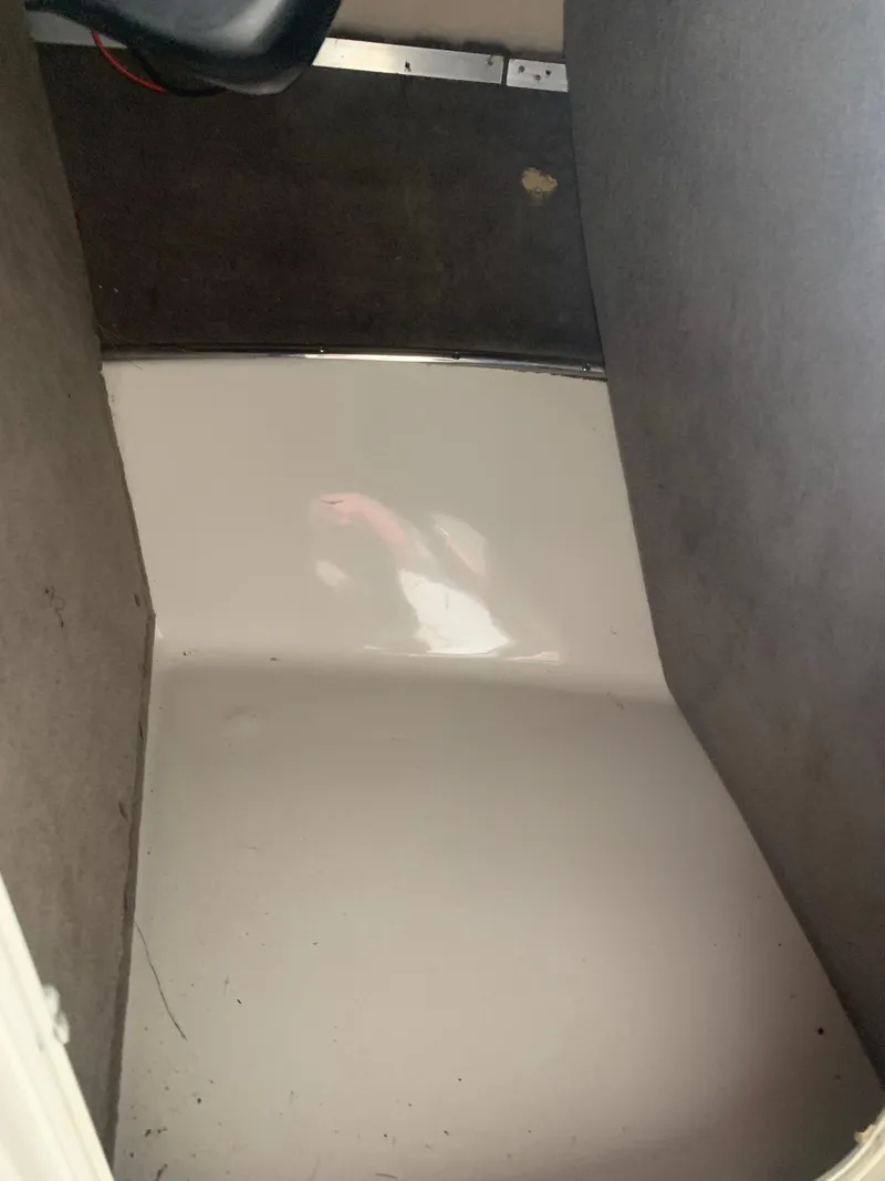 Slide: The Image of 2006 Bryant 206 BR boat interior, showing clean white floor and gray carpeted sides. - 23