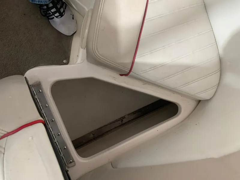 Slide: The Image of 2006 Bryant 206 BR boat seat storage compartment with red trim. - 25