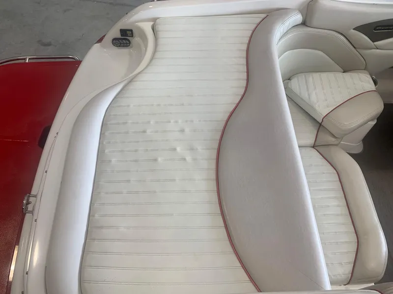 Slide: The Image of 2006 Bryant 206 BR boat interior with white and red-trimmed seating. - 29