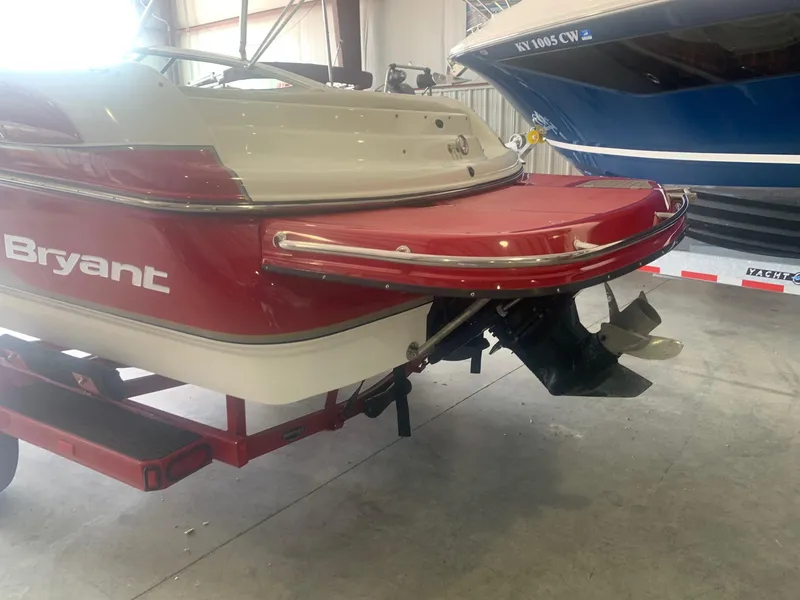 Slide: The Image of 2006 Bryant 206 BR boat in a garage, showcasing rear view and propeller. - 3
