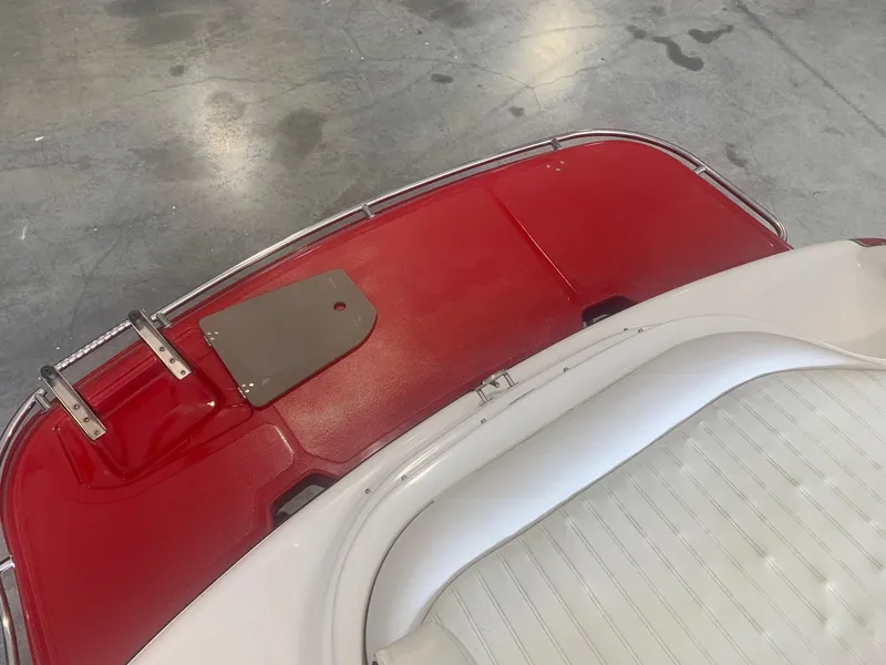 Slide: The Image of Red and white interior of a 2006 Bryant 206 BR boat, featuring seating and deck. - 30