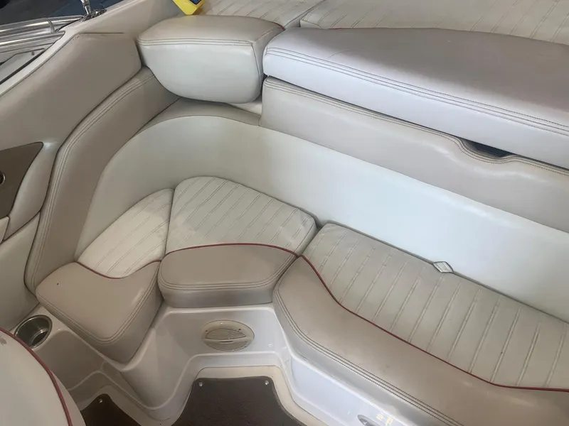 Slide: The Image of 2006 Bryant 206 BR boat interior with beige leather seating and red stitching. - 31