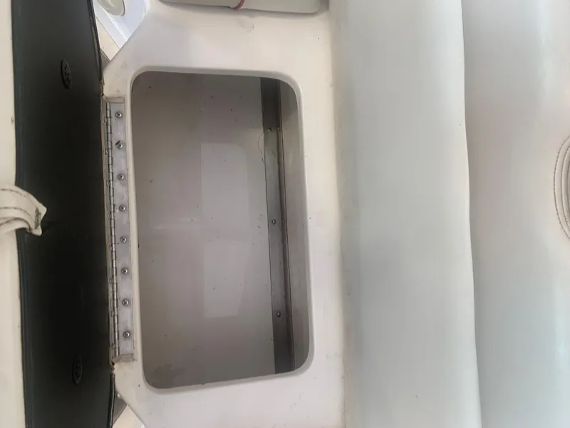 Slide: The Image of Open storage compartment in a 2006 Bryant 206 BR boat interior. - 32