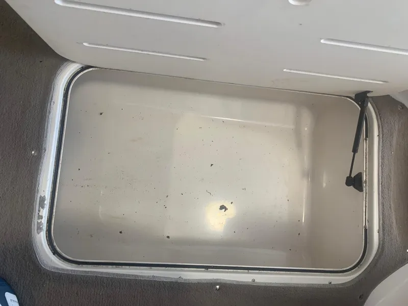 Slide: The Image of Open storage compartment in a 2006 Bryant 206 BR boat. - 33