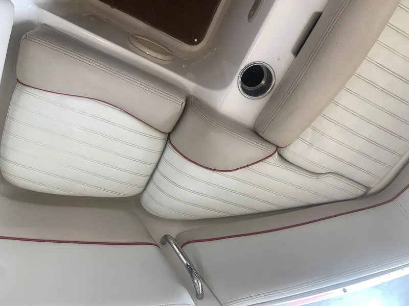 Slide: The Image of 2006 Bryant 206 BR boat interior with white and beige seating, red piping, and chrome accents. - 37