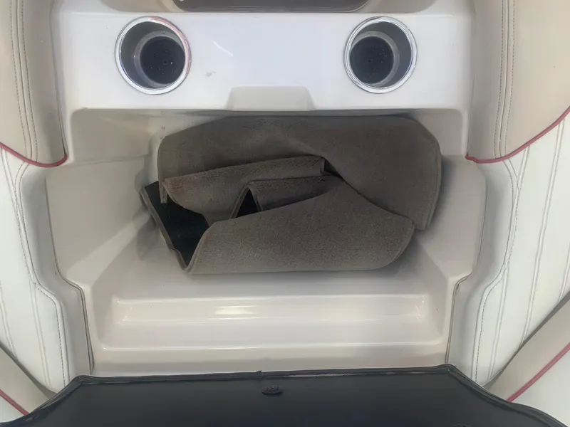 Slide: The Image of Storage compartment in a 2006 Bryant 206 BR boat with cup holders and carpet. - 38