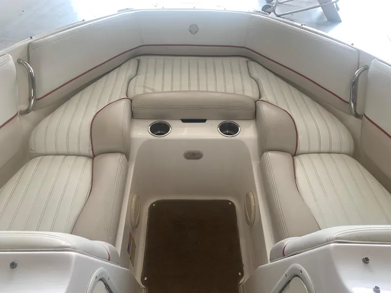 Slide: The Image of 2006 Bryant 206 BR boat interior with white cushioned seating and cup holders. - 40