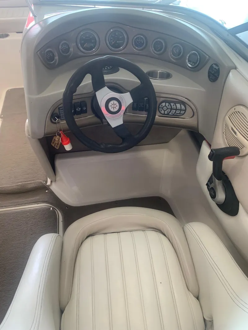 Slide: The Image of 2006 Bryant 206 BR boat interior with steering wheel and dashboard controls. - 44