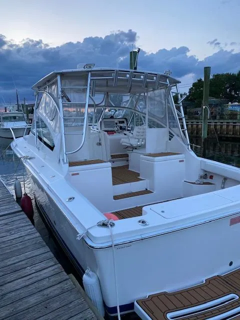 Slide: The Image of 2006 Luhrs 28 Open boat docked at marina during twilight. - 10