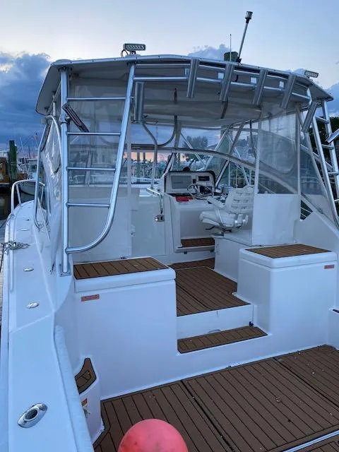 Slide: The Image of 2006 Luhrs 28 Open boat with spacious deck and seating, docked at sunset. - 12