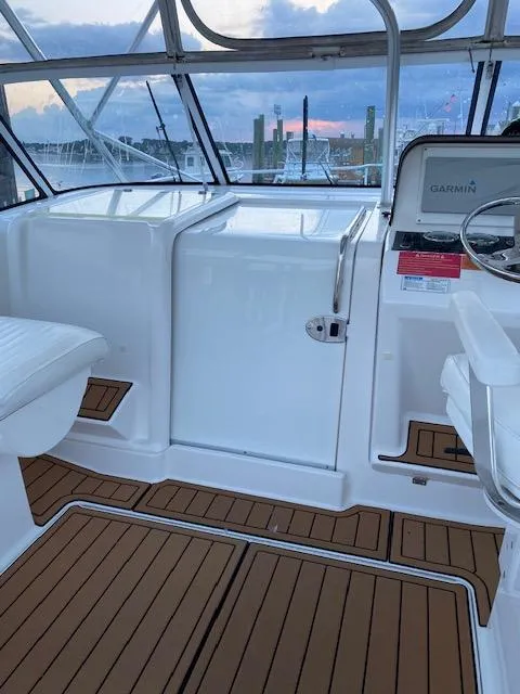Slide: The Image of 2006 Luhrs 28 Open boat interior with teak flooring and Garmin equipment. - 14