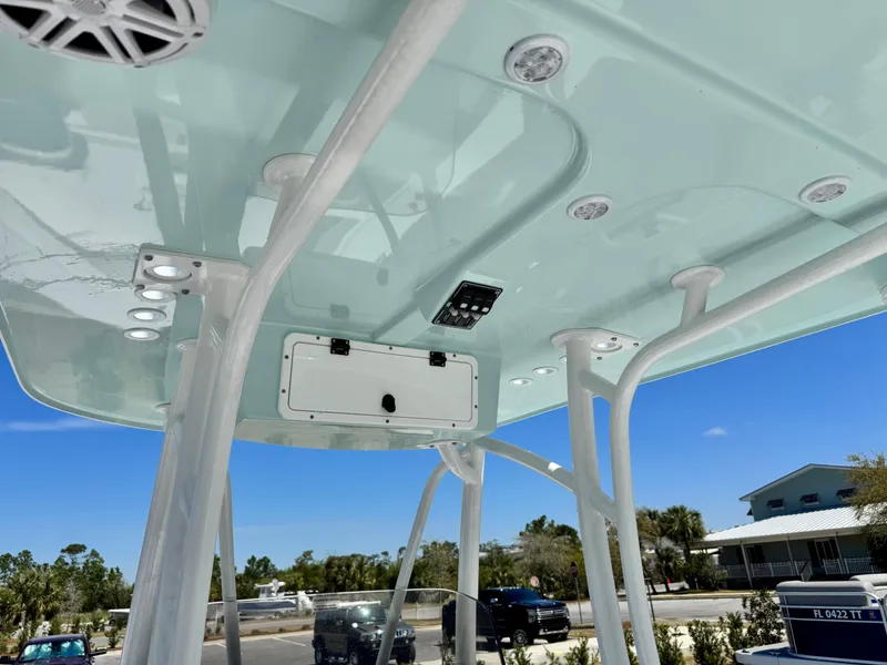 Slide: The Image of 2025 BlackJack 256 Coastal boat canopy with speakers and lights, set against a clear blue sky. - 11