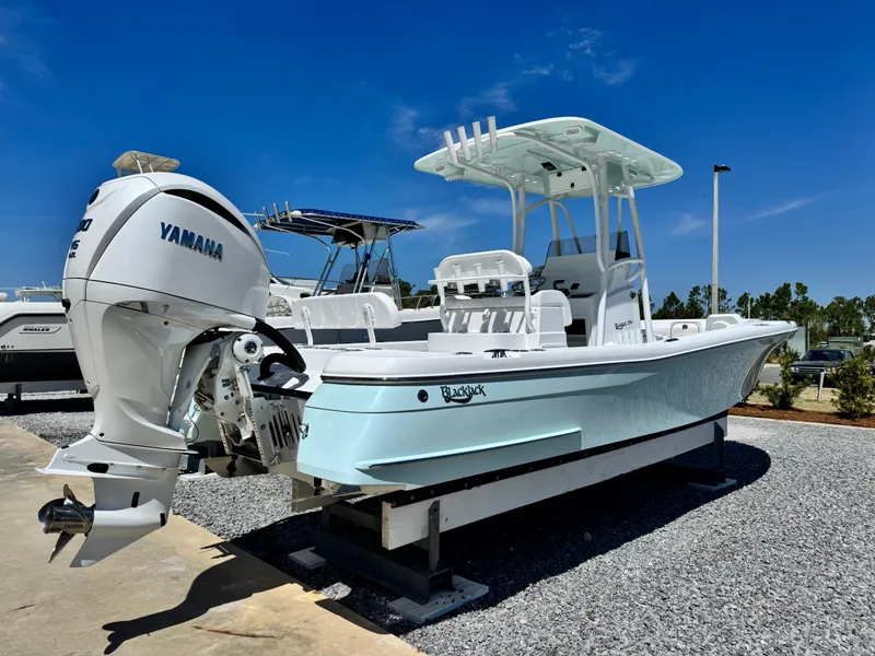 Slide: The Image of 2025 BlackJack 256 Coastal boat with Yamaha engine, displayed outdoors on gravel. - 3