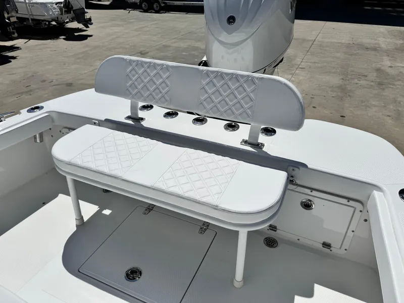 Slide: The Image of 2025 BlackJack 256 Coastal boat interior with white cushioned seating and storage compartments. - 7
