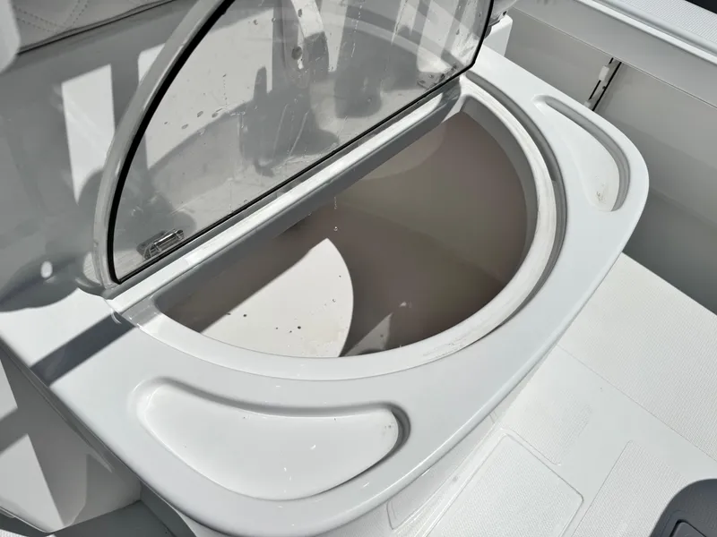 Slide: The Image of Livewell compartment on 2025 BlackJack 256 Coastal boat, open with clear lid. - 9