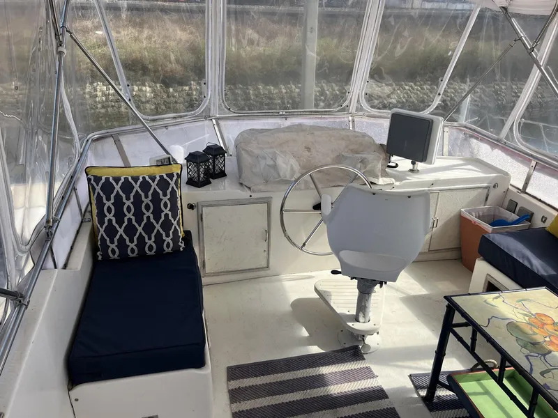 Slide: The Image of 1987 Jefferson 42 SE Sundeck Motor Yacht interior with helm, seating, and nautical decor. - 13