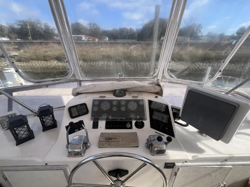 Slide: The Image of 1987 Jefferson 42 SE Sundeck Motor Yacht helm with navigation instruments and controls. - 16