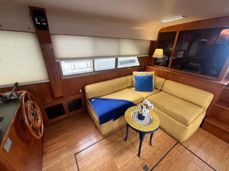Slide: The Image of Interior of 1987 Jefferson 42 SE Sundeck Motor Yacht with cozy seating and nautical decor. - 17