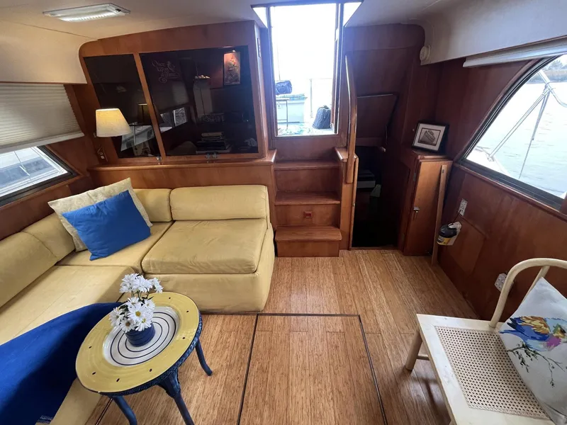 Slide: The Image of Interior of 1987 Jefferson 42 SE Sundeck Motor Yacht with cozy seating and wooden decor. - 18