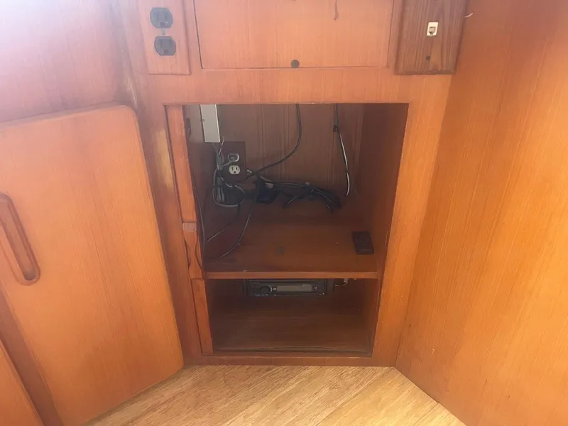 Slide: The Image of 1987 Jefferson 42 SE Sundeck Motor Yacht interior cabinet with electrical components. - 22