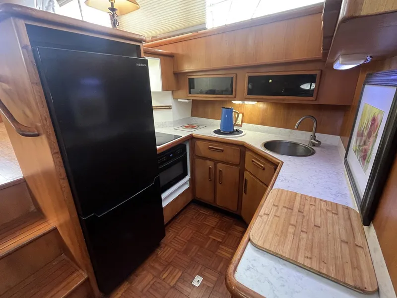 Slide: The Image of 1987 Jefferson 42 SE Sundeck Motor Yacht kitchen with fridge, stove, and sink. - 26