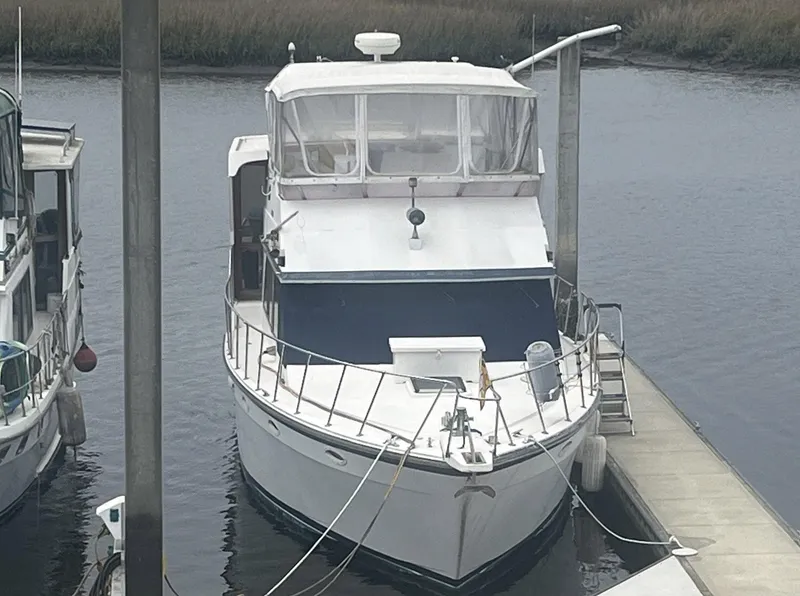 Slide: The Image of 1987 Jefferson 42 SE Sundeck Motor Yacht docked at marina. - 3