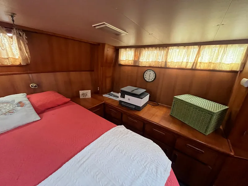 Slide: The Image of Cozy cabin interior of 1987 Jefferson 42 SE Sundeck Motor Yacht with bed and wooden furnishings. - 33