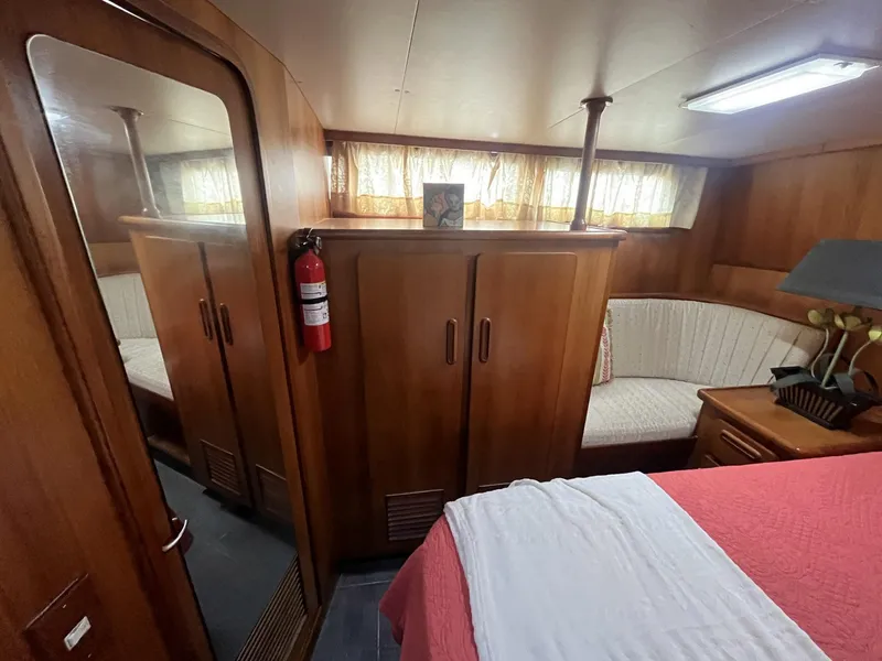 Slide: The Image of Interior of 1987 Jefferson 42 SE Sundeck Motor Yacht with wood paneling and cozy seating. - 35