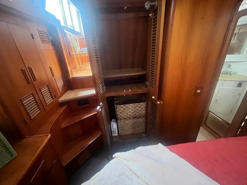 Slide: The Image of 1987 Jefferson 42 SE Sundeck Motor Yacht interior with wooden cabinetry and open closet. - 38