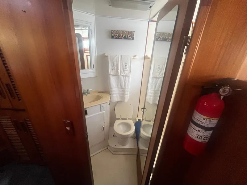 Slide: The Image of 1987 Jefferson 42 SE Sundeck Motor Yacht bathroom with sink, toilet, and mirror. - 39