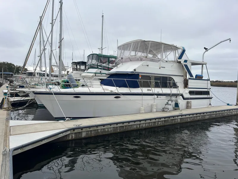 Slide: The Image of 1987 Jefferson 42 SE Sundeck Motor Yacht docked at marina, overcast sky. - 4