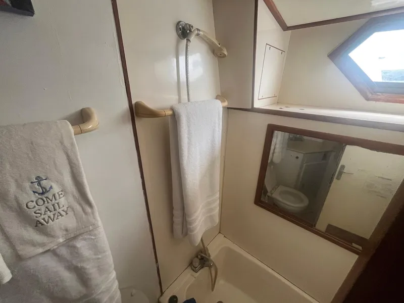 Slide: The Image of Bathroom interior of 1987 Jefferson 42 SE Sundeck Motor Yacht with towel and mirror. - 42