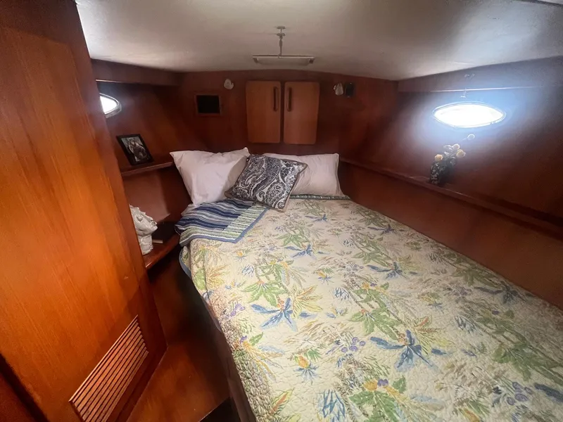 Slide: The Image of Cozy bedroom in 1987 Jefferson 42 SE Sundeck Motor Yacht with floral bedding and wood paneling. - 45