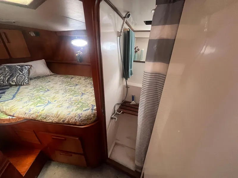 Slide: The Image of 1987 Jefferson 42 SE Sundeck Motor Yacht interior with bed and shower area. - 49