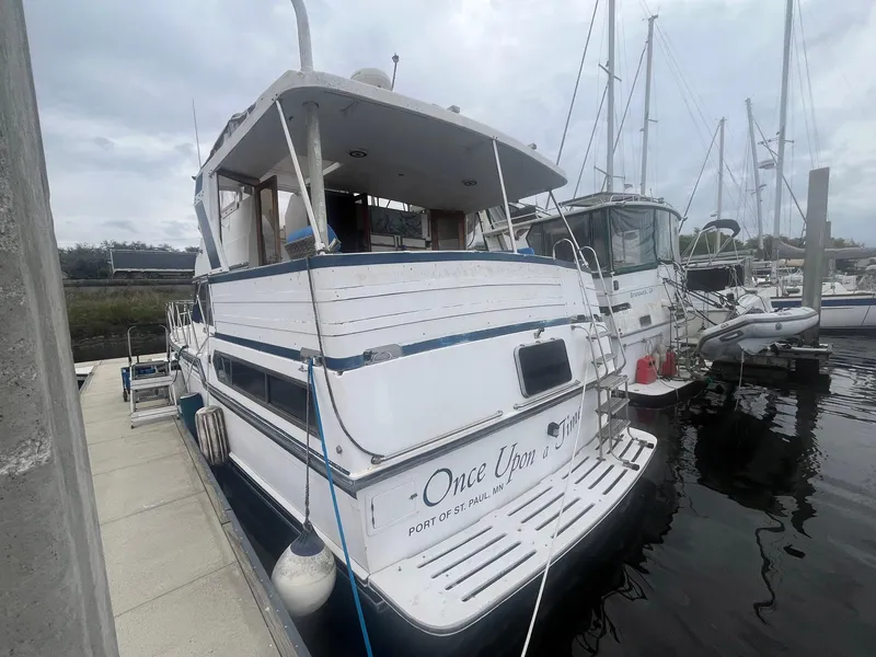 Slide: The Image of 1987 Jefferson 42 SE Sundeck Motor Yacht docked at marina, rear view. - 5