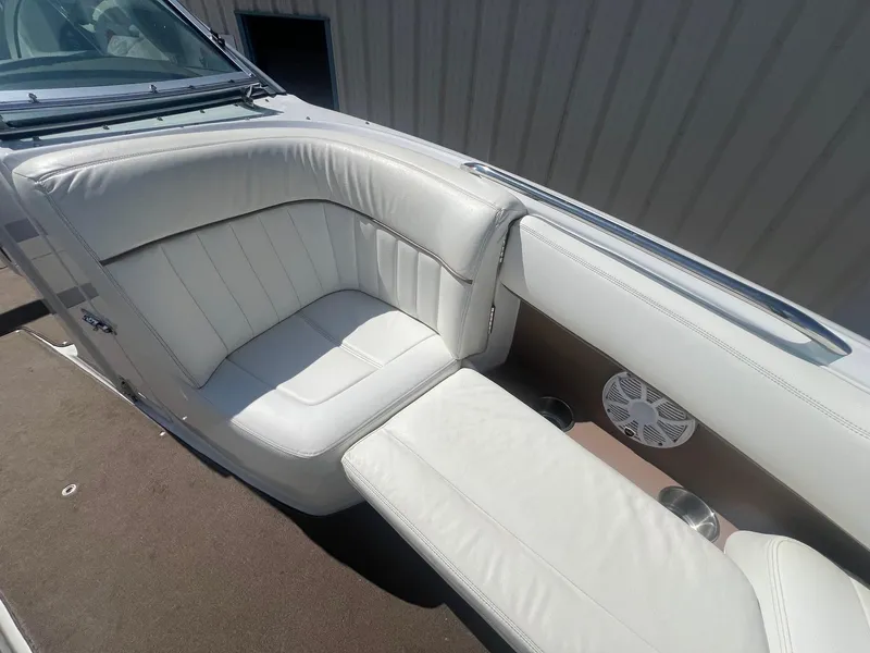 Slide: The Image of 2007 Cobalt 232 boat interior with white leather seating and speaker. - 12